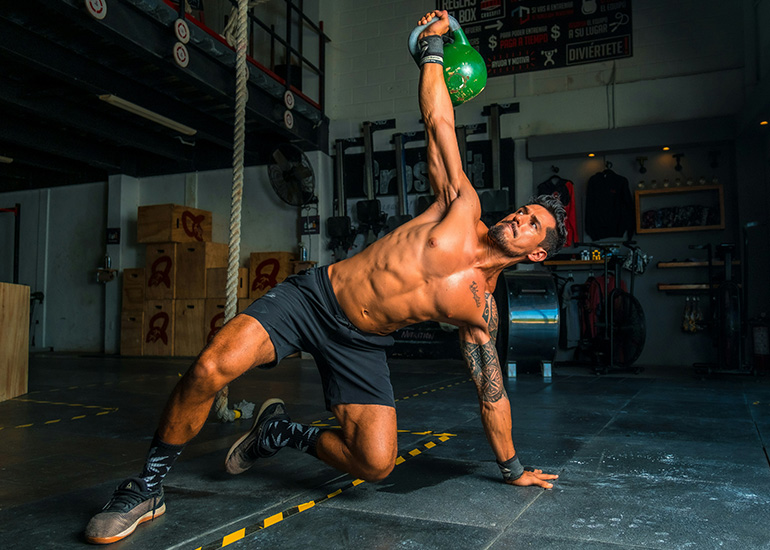 Man performing a kettlebell workout in a gym