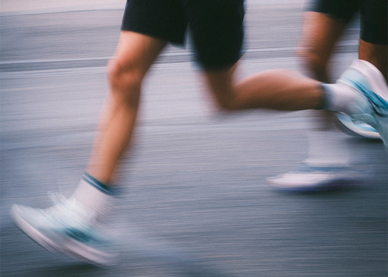 Close-up of a runner's legs mid-stride