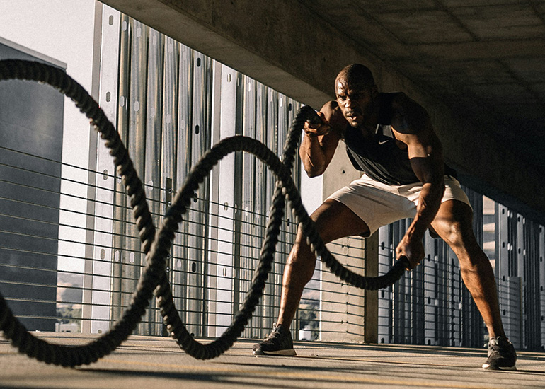 Athlete performing battle rope exercises