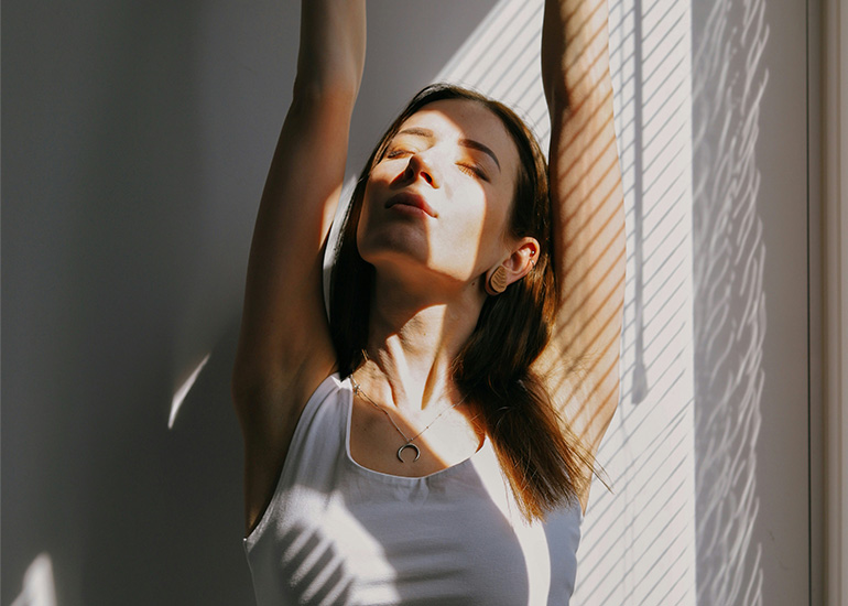 Woman relaxing and stretching as part of a wellness routine