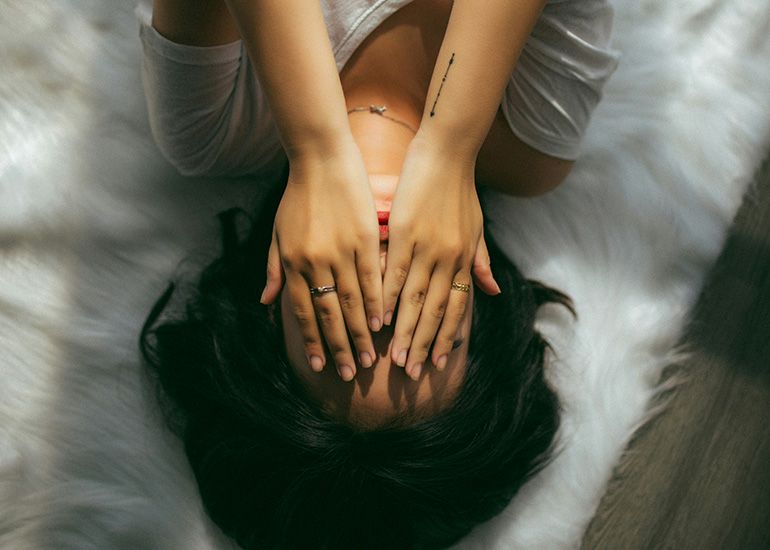 Woman resting while experiencing dehydration symptoms